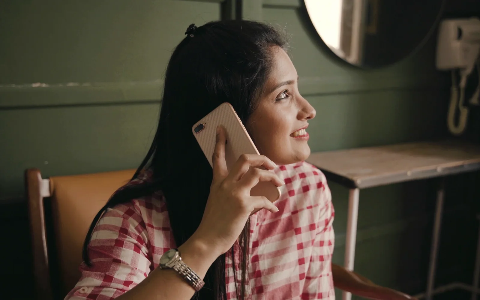 A young woman on a phone call, smiling